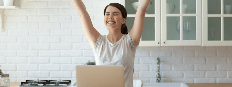 Woman happy at laptop